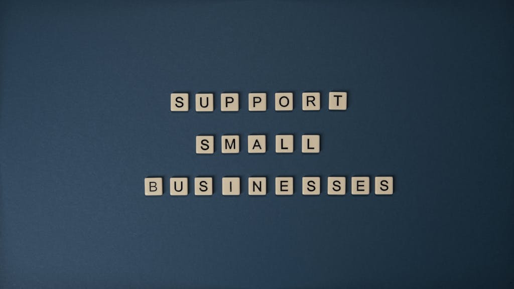 Best Digital Advertising Services For Small Business - Letter tiles spelling 'Support Small Businesses' on a blue background, promoting local entrepreneurship.